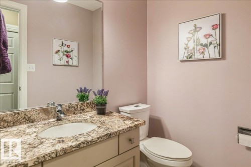 Bathroom featuring a vanity with a granite countertop, an undermount sink, and a toilet - 954 Rice Road, Edmonton, AB - Indoor Photo Showing Bathroom