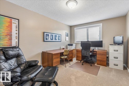 This room features a window with blinds, light-colored walls, and a textured ceiling - 954 Rice Road, Edmonton, AB - Indoor Photo Showing Office