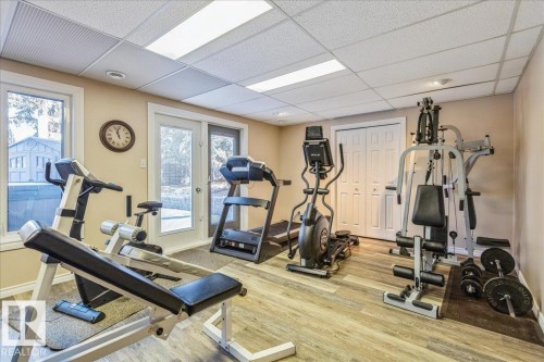 The property features a versatile room with light-colored walls and wood-look flooring - 954 Rice Road, Edmonton, AB - Indoor Photo Showing Gym Room