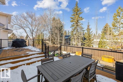 The property features a multi-level wooden deck with black railings - 954 Rice Road, Edmonton, AB - Outdoor With Deck Patio Veranda