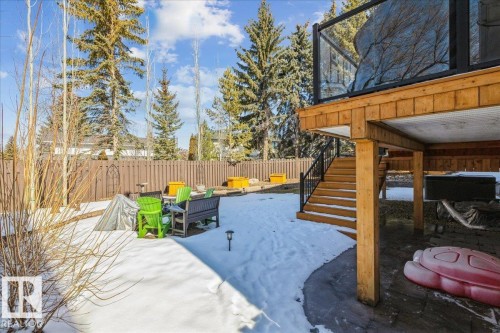 The property features an extensive yard with a wooden fence and mature trees - 954 Rice Road, Edmonton, AB - Outdoor