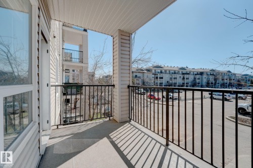 Outdoor balcony featuring a concrete surface, black metal railings, and a siding exterior - 7226 7327 South Terwillegar Drive, Edmonton, AB - Outdoor With Exterior