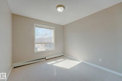 Carpeted room with a double-paned window and baseboard heating - 