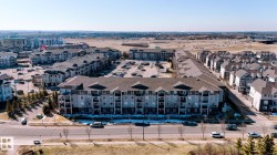 Contemporary multi-level apartment building featuring private balconies, ample on-site parking, and a cohesive architectural design - 