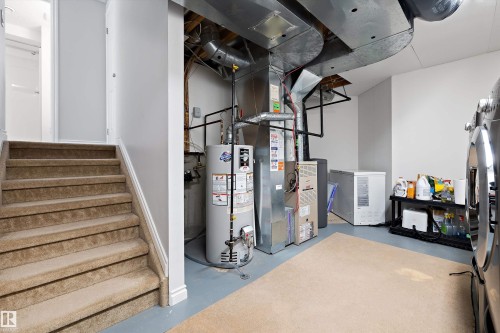 Utility area featuring a water heater, furnace, and exposed ductwork - 1811 37 Avenue, Edmonton, AB - Indoor