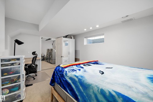 Carpeted room featuring a built-in desk, recessed lighting, and a window - 1811 37 Avenue, Edmonton, AB - Indoor Photo Showing Bedroom