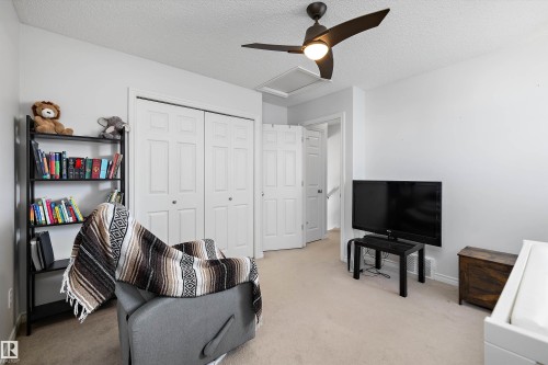 Light-colored wall finishes, soft carpet flooring, and a ceiling fan with integrated lighting - 1811 37 Avenue, Edmonton, AB - Indoor