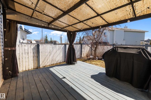 Expansive wood-finish deck featuring a permanent gazebo structure with a corrugated roof - 1811 37 Avenue, Edmonton, AB - Outdoor With Deck Patio Veranda With Exterior
