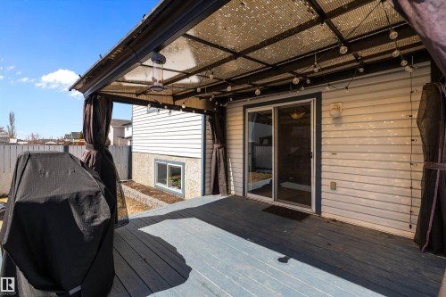 Covered deck with grey wood-finish flooring - 1811 37 Avenue, Edmonton, AB - Outdoor With Exterior
