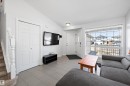 Bright living space featuring a large picture window, wood-finish flooring, and white walls - 1811 37 Avenue, Edmonton, AB  - Indoor Photo Showing Living Room 