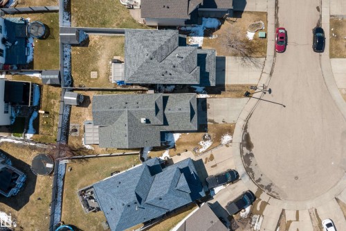Residential property with a dark shingle roof, a paved driveway, and an attached garage - 1811 37 Avenue, Edmonton, AB - 