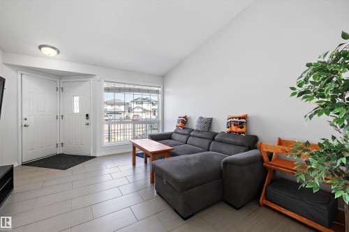 Spacious living area featuring light-toned plank flooring and a large window - 1811 37 Avenue, Edmonton, AB - Indoor Photo Showing Living Room