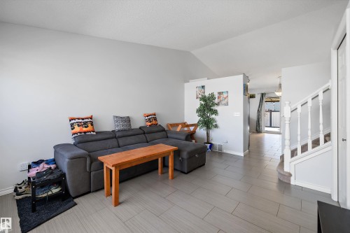 Spacious interior featuring vaulted ceilings and light gray walls - 1811 37 Avenue, Edmonton, AB - Indoor Photo Showing Other Room
