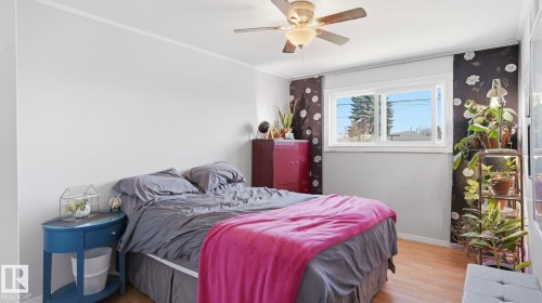 Room featuring a window with white trim, wood-finish flooring, and a ceiling fan with integrated lighting - 13533 119 Street, Edmonton, AB - Indoor Photo Showing Bedroom
