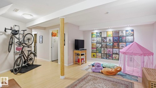 Spacious interior featuring light wood-finish flooring, recessed lighting, and a neutral color palette - 13533 119 Street, Edmonton, AB - Indoor