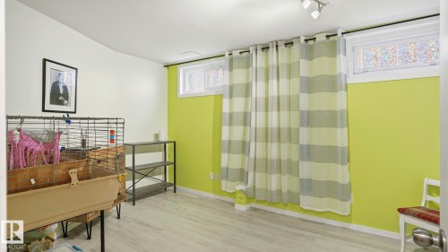 Room featuring light wood-finish flooring, white baseboards, and a combination of white and lime green painted walls - 13533 119 Street, Edmonton, AB - Indoor Photo Showing Bathroom