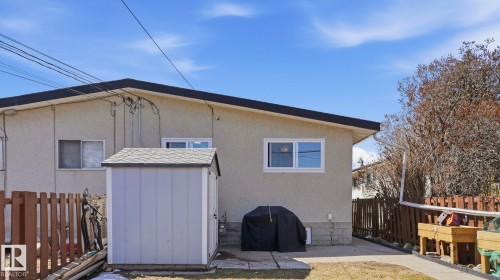 Rear exterior featuring stucco siding and a black shingle roof - 13533 119 Street, Edmonton, AB - Outdoor With Exterior