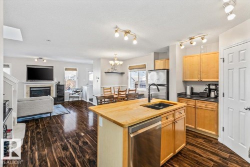 9310 Simpson Drive, Edmonton, AB - Indoor Photo Showing Kitchen With Fireplace With Double Sink