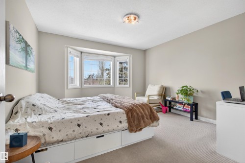 This room features light-colored carpeting, a bay window, and a ceiling-mounted light fixture - 2 Sturgeon Road, St. Albert, AB - Indoor Photo Showing Bedroom