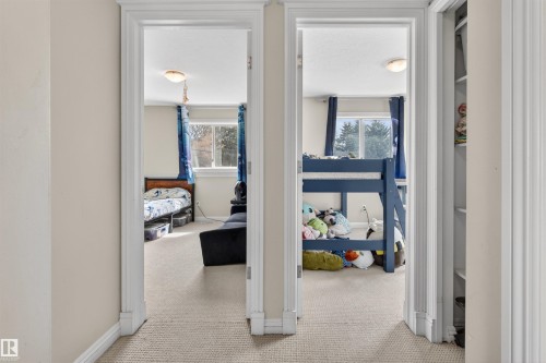 Hallway with carpet flooring and doorways leading to rooms with windows - 2 Sturgeon Road, St. Albert, AB - Indoor Photo Showing Other Room