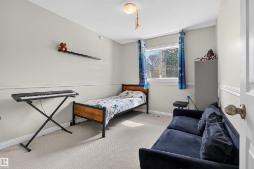 This room features light-colored walls, carpeted flooring, and a window providing natural light - 2 Sturgeon Road, St. Albert, AB - Indoor
