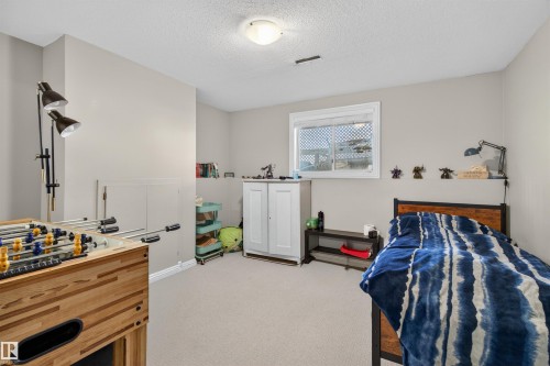 This bright room features a window, light-colored walls, and carpeted flooring - 2 Sturgeon Road, St. Albert, AB - Indoor Photo Showing Bedroom