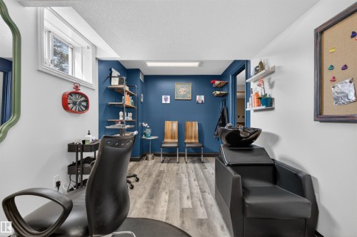 This versatile space features durable flooring, a window providing natural light, and distinctive blue accent walls - 2 Sturgeon Road, St. Albert, AB - Indoor