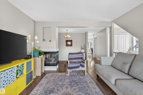 Inviting living space featuring hardwood floors, a fireplace with a visible firebox, and light-colored walls - 2 Sturgeon Road, St. Albert, AB - Indoor Photo Showing Living Room