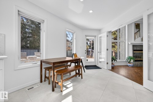 The property features an open-concept dining area with large format tile flooring and white walls - 1211 Hewgill Place, Edmonton, AB - Indoor