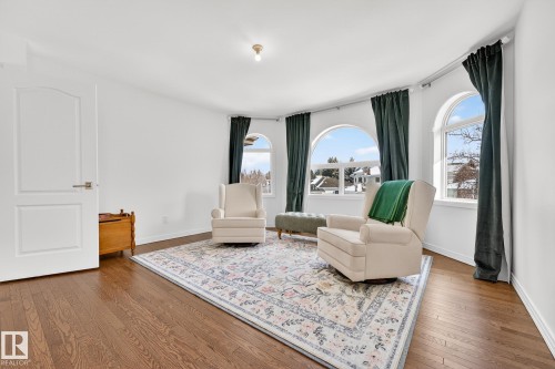 This room features hardwood floors and a large area rug with a floral pattern - 1211 Hewgill Place, Edmonton, AB - Indoor Photo Showing Living Room