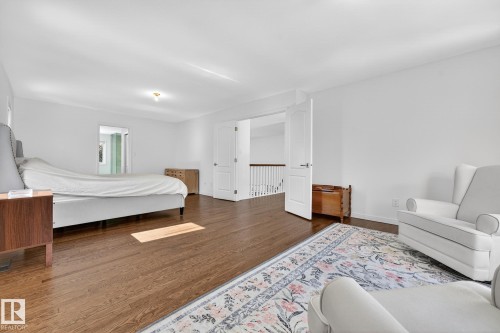 Spacious room featuring hardwood flooring, white walls, and bright overhead lighting - 1211 Hewgill Place, Edmonton, AB - Indoor Photo Showing Bedroom