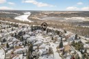 Aerial view showcasing the property within a neighborhood of detached residences, featuring a river and a bridge in the distance - 1211 Hewgill Place, Edmonton, AB  - Outdoor With View 