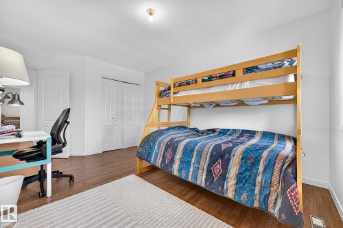 This room features hardwood flooring, white walls, and a white ceiling with an overhead light fixture - 1211 Hewgill Place, Edmonton, AB - Indoor Photo Showing Bedroom