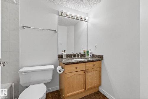 Bathroom featuring a light wood vanity with a granite countertop and a white toilet - 1211 Hewgill Place, Edmonton, AB - Indoor Photo Showing Bathroom