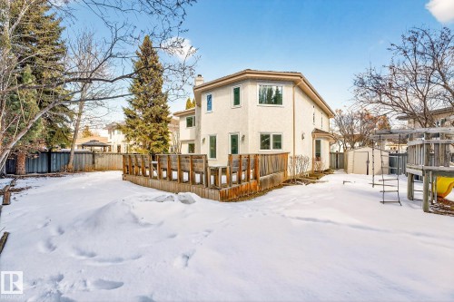 The property features a large yard with a wooden deck and privacy fencing - 1211 Hewgill Place, Edmonton, AB - Outdoor