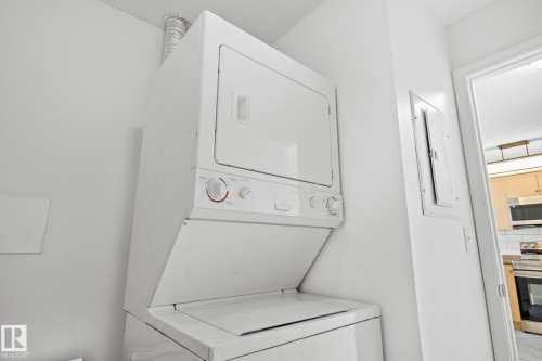This property includes a stacked washer and dryer unit, providing convenient in-unit laundry facilities - 105 4309 33 Street, Stony Plain, AB - Indoor Photo Showing Laundry Room