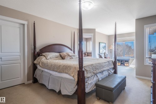 Carpeted bedroom with neutral wall tones and a white paneled door - 121 Ellington Crescent, St. Albert, AB - Indoor Photo Showing Bedroom