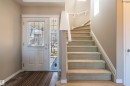 Entryway featuring a white paneled door with integrated blinds, a full-length sidelight, and a curved staircase with a white railing - 121 Ellington Crescent, St. Albert, AB  - Indoor Photo Showing Other Room 