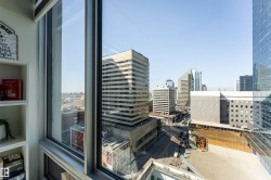 Floor-to-ceiling windows with aluminum framing providing expansive cityscape views - 