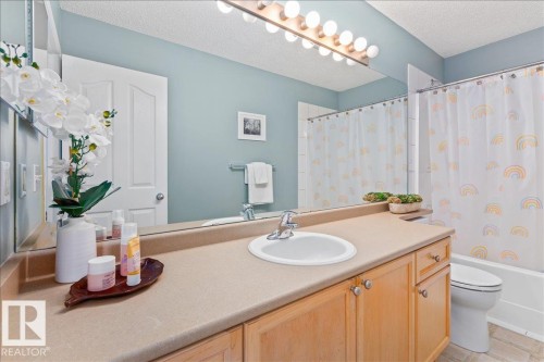 Bathroom featuring a single vanity with light wood cabinetry and a neutral countertop - 1130 Westerra Way, Stony Plain, AB - Indoor Photo Showing Bathroom