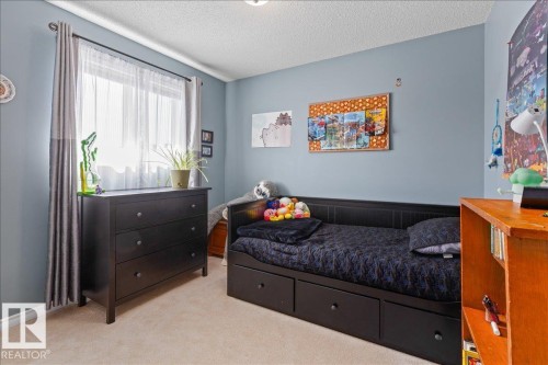 Room featuring light blue walls and neutral carpet flooring - 1130 Westerra Way, Stony Plain, AB - Indoor Photo Showing Bedroom