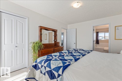 Bright bedroom featuring neutral wall tones and a textured ceiling - 1130 Westerra Way, Stony Plain, AB - Indoor Photo Showing Bedroom