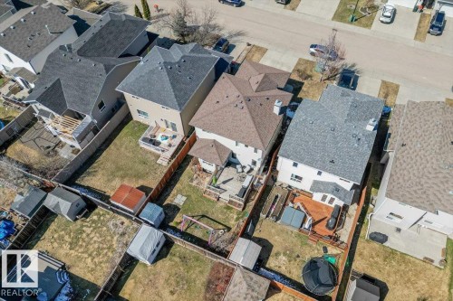 Residential property featuring a shingled roof, light-toned siding, and a rear deck with a fenced yard - 1130 Westerra Way, Stony Plain, AB -  With View