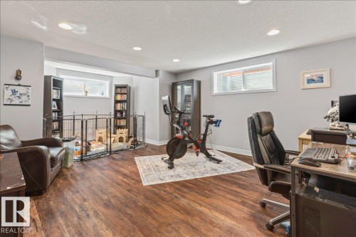 Spacious room featuring wood-finish flooring, recessed lighting, and light gray walls - 1130 Westerra Way, Stony Plain, AB - Indoor Photo Showing Gym Room