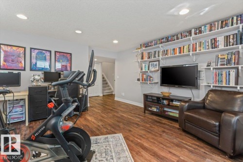 Spacious multi-purpose room featuring wood-finish flooring and recessed lighting - 1130 Westerra Way, Stony Plain, AB - Indoor Photo Showing Other Room