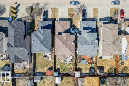 Aerial perspective showcasing multiple residential properties with pitched roofs, individual backyards, and paved driveways - 1130 Westerra Way, Stony Plain, AB - 