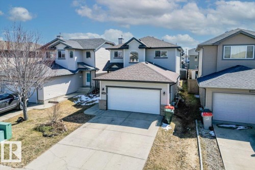 Two-story residence featuring light gray siding with dark trim accents and an attached two-car garage - 1130 Westerra Way, Stony Plain, AB - Outdoor With Facade