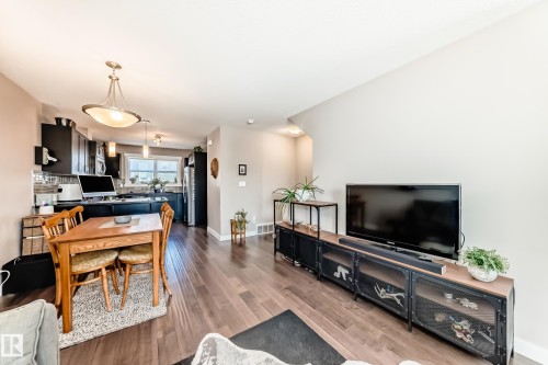 Open-concept living space featuring wood-finish flooring throughout - 115 401 Southfork Drive, Leduc, AB - Indoor Photo Showing Living Room