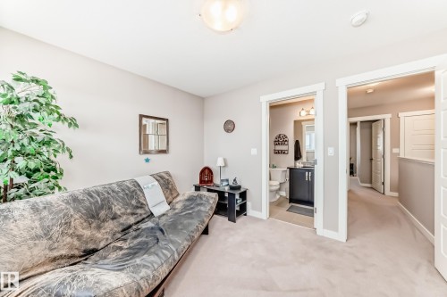 Carpeted room featuring light gray walls, white trim, and a flush-mount ceiling light - 115 401 Southfork Drive, Leduc, AB - Indoor Photo Showing Living Room