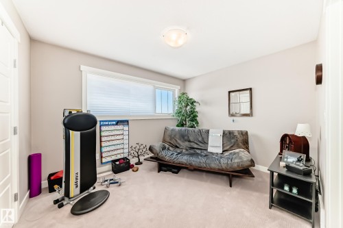 Spacious room featuring neutral carpeting and light-colored walls - 115 401 Southfork Drive, Leduc, AB - Indoor